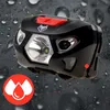 A black LED headlamp with a red button and a silver bezel is shown against a dark, wet background. A red circular icon with three white water drops is in the lower left corner. Náhled obrázku produktu