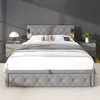 A modern bedroom with a grey upholstered bed as the main focus. Produktbild-Vorschau