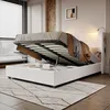 A bedroom scene with a bed that has its storage compartment open, revealing items stored inside. The bed is placed on a rug in front of a window with blinds. Náhľad obrázku produktu