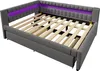 A grey upholstered bed frame with a wooden slat support system and purple LED lighting along the headboard. Produktbild-Vorschau
