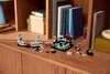 A small LEGO castle set is displayed on a wooden shelf, surrounded by books and other decorative items. Produktbild-Vorschau