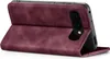 A burgundy flip cover case for a Google Pixel phone is shown standing upright. Produktbild-Vorschau