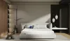 A modern bedroom with a large white bed as the focal point. Produktbild-Vorschau