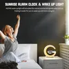 A woman waking up in bed next to a sunrise alarm clock. Produktbild-Vorschau