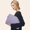 A woman holding a laptop sleeve. Náhled obrázku produktu
