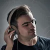A man wearing headphones and listening to music. Anteprima dell’immagine prodotto