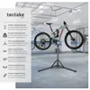 A bicycle repair stand with a bicycle mounted on it, in a garage setting. Náhled obrázku produktu