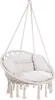 A beige macrame hanging chair with cushions, suspended by ropes. Náhled obrázku produktu