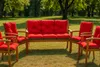 Outdoor furniture set with red cushions on a grassy lawn. Produktbild-Vorschau