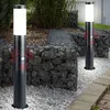Two modern black bollard lights with motion sensors are placed in a garden setting with gabion walls filled with stones. Produktbild-Vorschau