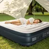 A woman sleeping on an inflatable mattress under a canopy outdoors. Podgląd zdjęcia produktu