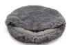 A round, fluffy pet bed with a deep center, shown from a slightly elevated angle. Produktbild-Vorschau