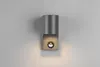 A modern wall lamp with a cylindrical top and a square base, mounted on a light gray wall. Produktbild-Vorschau