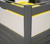 A close-up view of the corner of a gray metal trash can enclosure with yellow and white accents. Náhled obrázku produktu