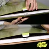 A close-up of hands holding and interacting with a painting by numbers kit. Produktbild-Vorschau