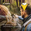 Two people in outdoor clothing looking at something in the woods. Voir les images du produit