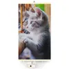 A close-up of a kitten looking out a window, printed on a heating panel. Produktbild-Vorschau