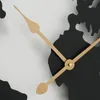 A close-up view of a wall clock with a world map design and golden hands. Anteprima dell’immagine prodotto