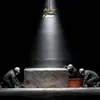 Three workers in hard hats and masks are gathered around a large stone block under a spotlight. Anteprima dell’immagine prodotto