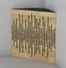 A corner acoustic panel with a wood grain finish and black vertical slots, placed in a room corner. Náhled obrázku produktu