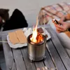 People making s'mores around a small fire pit on a wooden table. Produktbild-Vorschau