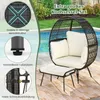 A rattan egg chair with cushions and an ottoman, placed on a rug next to a swimming pool. Anteprima dell’immagine prodotto