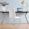 A white faux leather cantilever chair is placed in front of a dark brown desk with a laptop, a vase with dried plants, and a lamp. Podgląd zdjęcia produktu