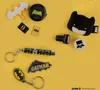 A collection of Batman-themed merchandise laid out on a yellow background. Produktbild-Vorschau