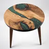 A round wooden coffee table with a green resin inlay, shown on a white background. Produktbild-Vorschau
