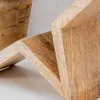 A close-up view of a wooden star decoration, showing the texture and grain of the wood. Produktbild-Vorschau