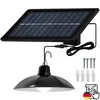 A solar-powered hanging lamp with its solar panel and mounting hardware. Anteprima dell’immagine prodotto