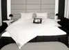 A neatly made bed with white bedding and a headboard. Produktbild-Vorschau