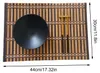 A bamboo placemat with a black bowl and chopsticks on it, with dimensions indicated. Produktbild-Vorschau