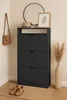 A shoe cabinet with three drawers, a mirror, a hat, a framed picture, a handbag, a vase with dried flowers, and a pair of shoes on a mat. Produktbild-Vorschau