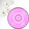 A pink planter with concentric circles is shown next to several white orchid flowers on a white and light gray background. Anteprima dell’immagine prodotto