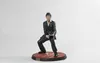 A figurine of Tony Montana from Scarface is posed on a red circular base. Podgląd zdjęcia produktu