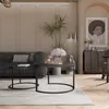 A living room scene with a sofa, coffee tables, and artwork. Voir les images du produit