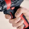 A hand holding a cordless drill. Voir les images du produit