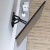 A TV wall mount is attached to a wall, with a TV screen angled away from the wall and towards the viewer. Voir les images du produit