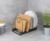 A kitchen counter with a plate and cutting board organizer, a small potted plant, and a canister. Anteprima dell’immagine prodotto