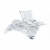 A white pillow and comforter are displayed on a white background. Produktbild-Vorschau