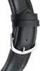 A close-up of a black leather watch strap with a silver buckle. Produktbild-Vorschau