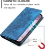 A blue flip case for a smartphone with a mandala pattern is shown open, revealing the phone screen. Arrows indicate the magnetic closure feature. Produktbild-Vorschau