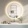 A modern bathroom vanity with a round LED mirror, sink, faucet, and toiletries. Voir les images du produit