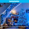 A festive Christmas scene with stairs decorated with blue lights, a Christmas tree, and a fireplace. Produktbild-Vorschau