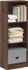 A tall, narrow bookshelf with three shelves, filled with books and a storage box. Podgląd zdjęcia produktu
