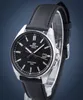 A close-up studio shot of a black leather strap watch with a black dial, displayed on a clear stand against a dark blue background. Voir les images du produit