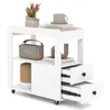 A white rolling side table with two drawers and open shelves, decorated with a plant, books, a cup, and a portable speaker. Produktbild-Vorschau