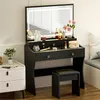 A black vanity table with a lighted mirror and a stool, set up in a room. Produktbild-Vorschau