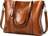A close-up studio shot of a brown leather handbag. Produktbild-Vorschau